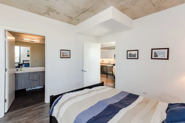 a bedroom with a bed and a bathroom