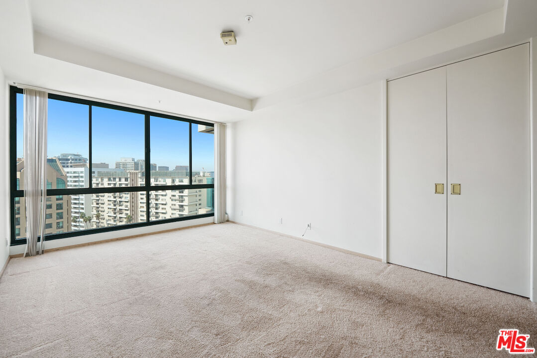 10490 Wilshire Boulevard, Unit 1402 Los Angeles, CA 90024 - Photo 16 of 67 a view of an empty room with a sliding door