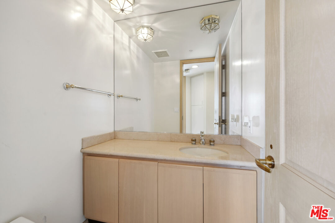 10490 Wilshire Boulevard, Unit 1402 Los Angeles, CA 90024 - Photo 19 of 67 a bathroom with a sink and a mirror
