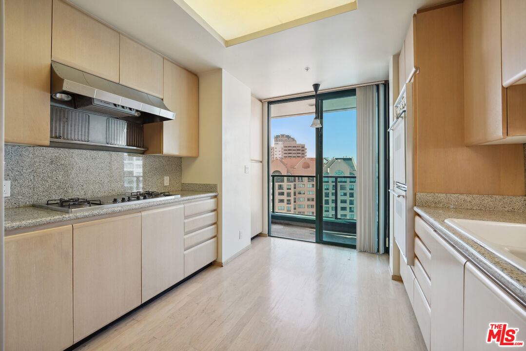 10490 Wilshire Boulevard, Unit 1402 Los Angeles, CA 90024 - Photo 3 of 67 a kitchen with stainless steel appliances granite countertop a stove and a refrigerator