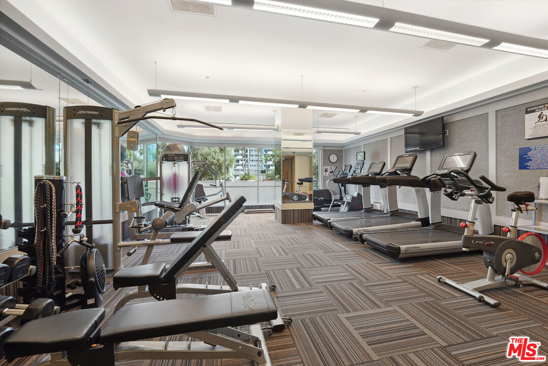 10490 Wilshire Boulevard, Unit 1402 Los Angeles, CA 90024 - Photo 31 of 67 a view of a room with gym equipment