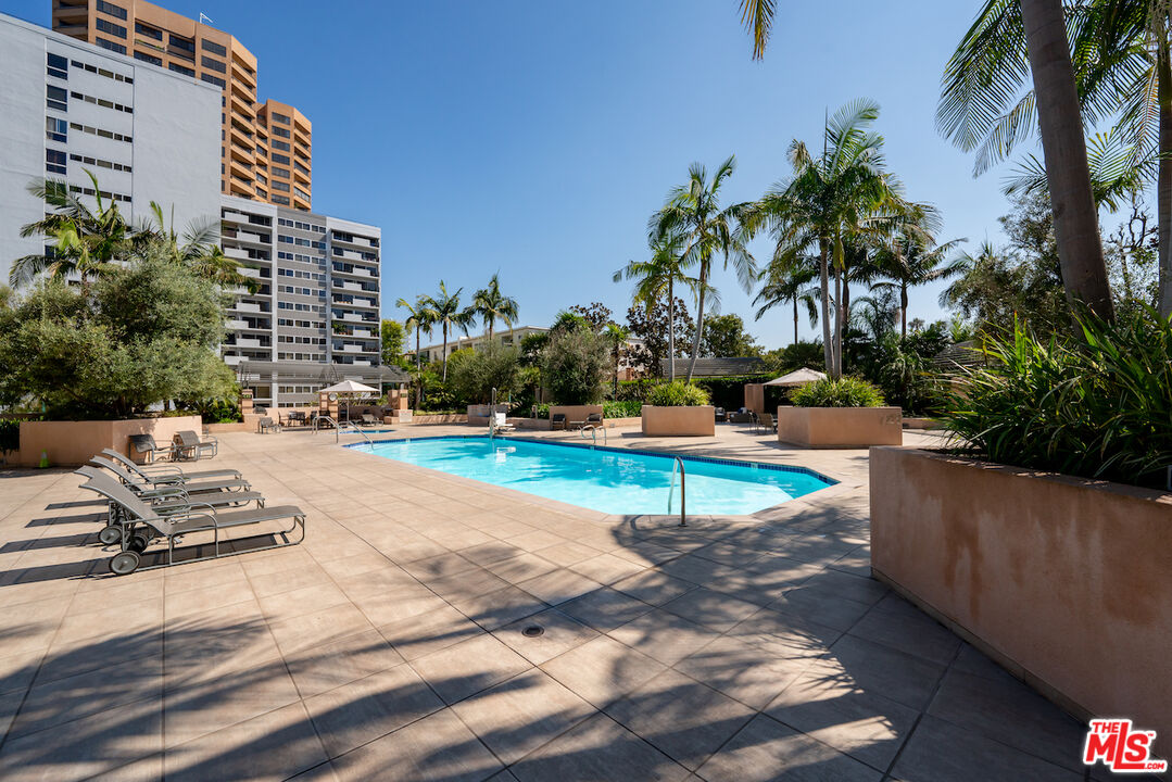 10490 Wilshire Boulevard, Unit 1402 Los Angeles, CA 90024 - Photo 37 of 67 a view of a swimming pool with a lounge chair