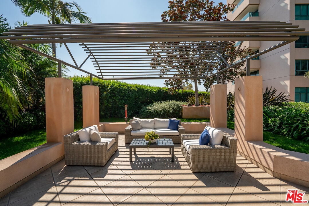 10490 Wilshire Boulevard, Unit 1402 Los Angeles, CA 90024 - Photo 44 of 67 a view of a patio with couches table and chairs and potted plants