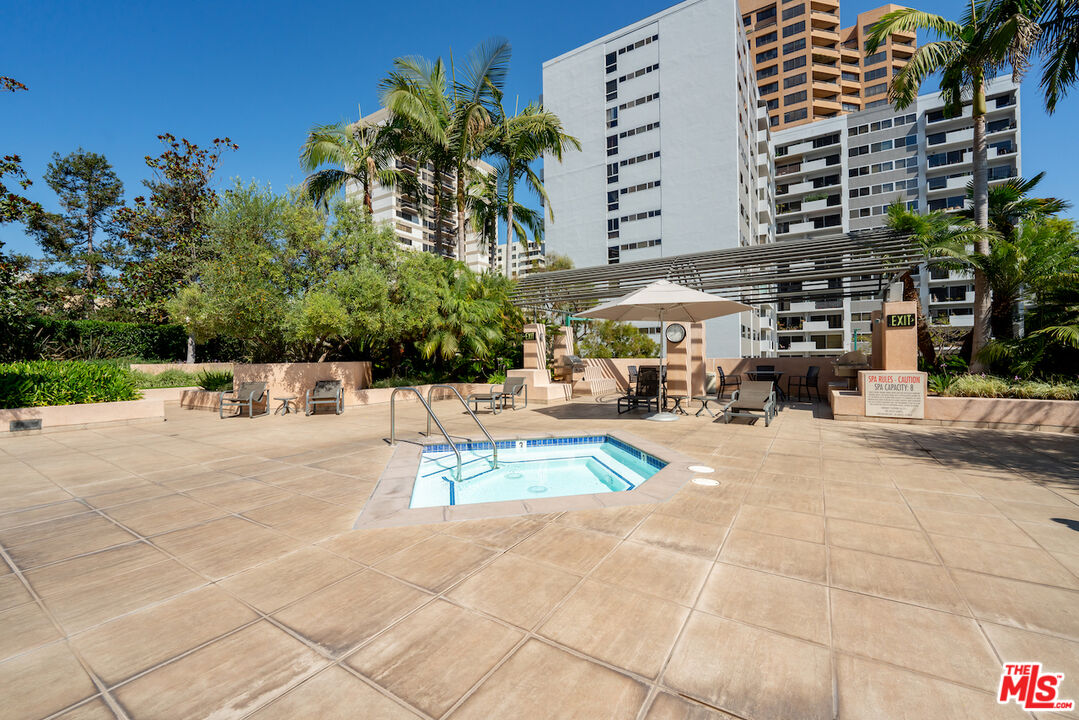 10490 Wilshire Boulevard, Unit 1402 Los Angeles, CA 90024 - Photo 46 of 67 a view of a swimming pool with a lounge chair