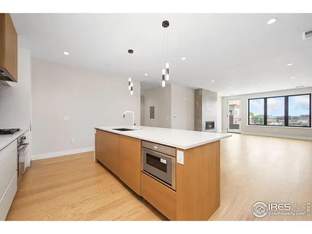 a view of kitchen with stainless steel appliances granite countertop cabinets and wooden floor