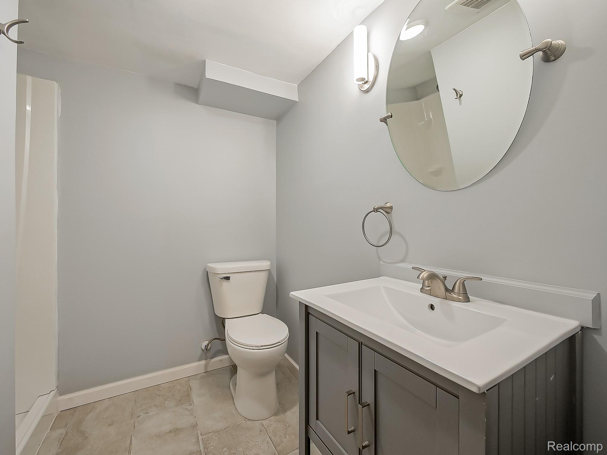 42195 Park Ridge Road Novi, MI 48375 - Photo 35 of 52 Gray vanity with integrated sink, coordinating wall mirror, and brushed nickel fixtures