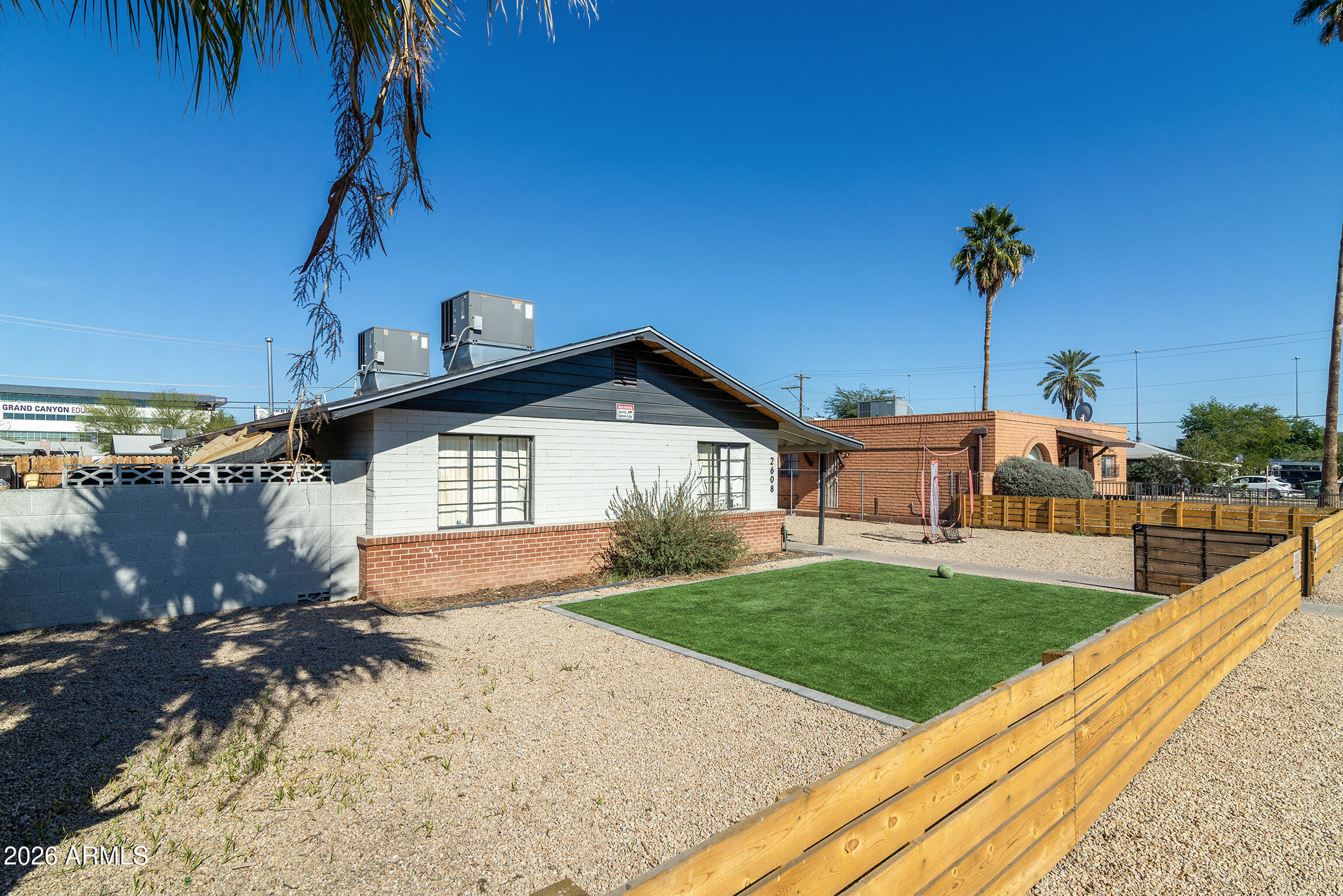 2608 West Pierson Street Phoenix, AZ 85017 - Photo 18 of 32 a front view of a house with a yard and garage
