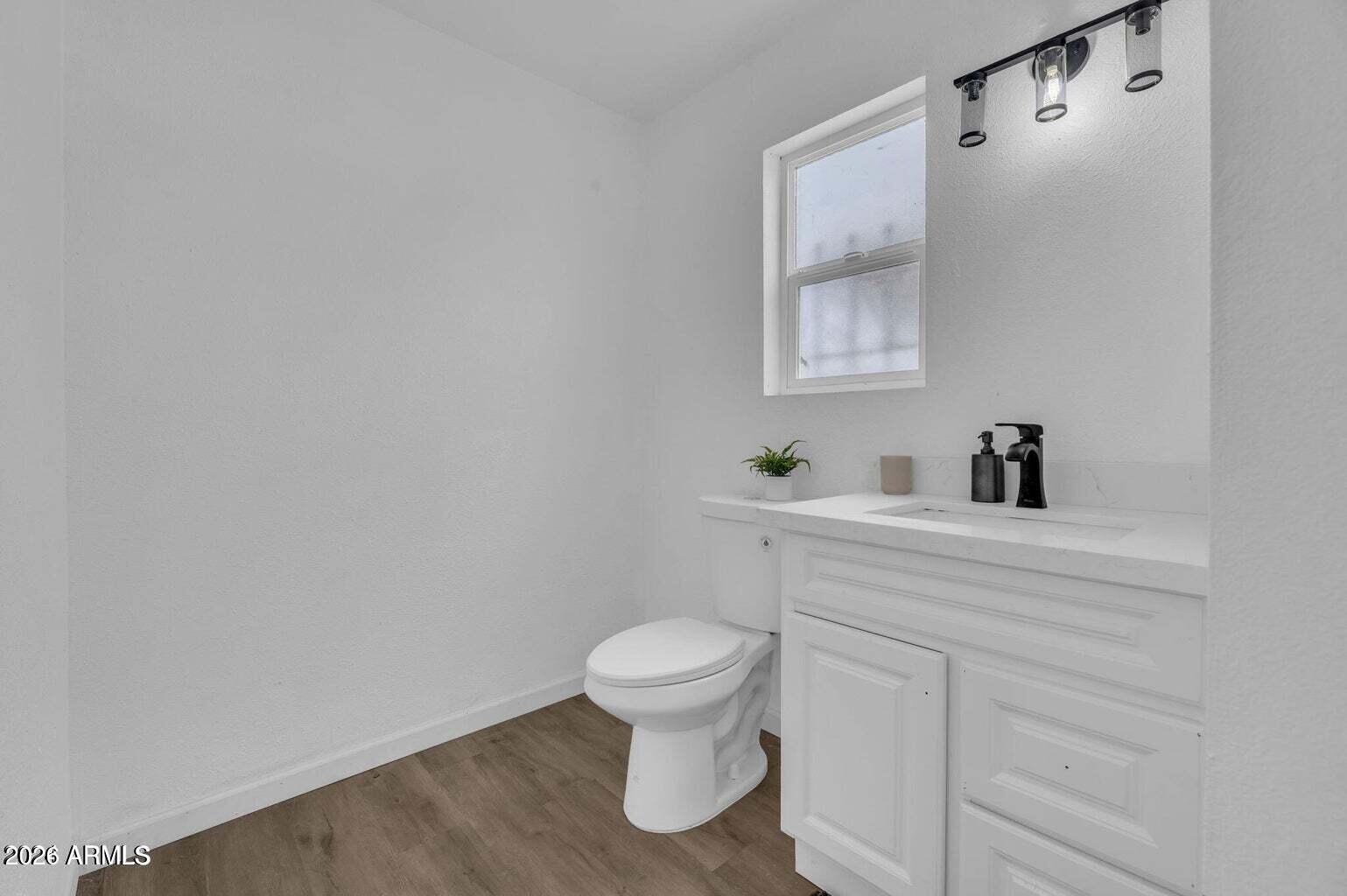 2608 West Pierson Street Phoenix, AZ 85017 - Photo 25 of 32 a bathroom with a toilet sink and mirror
