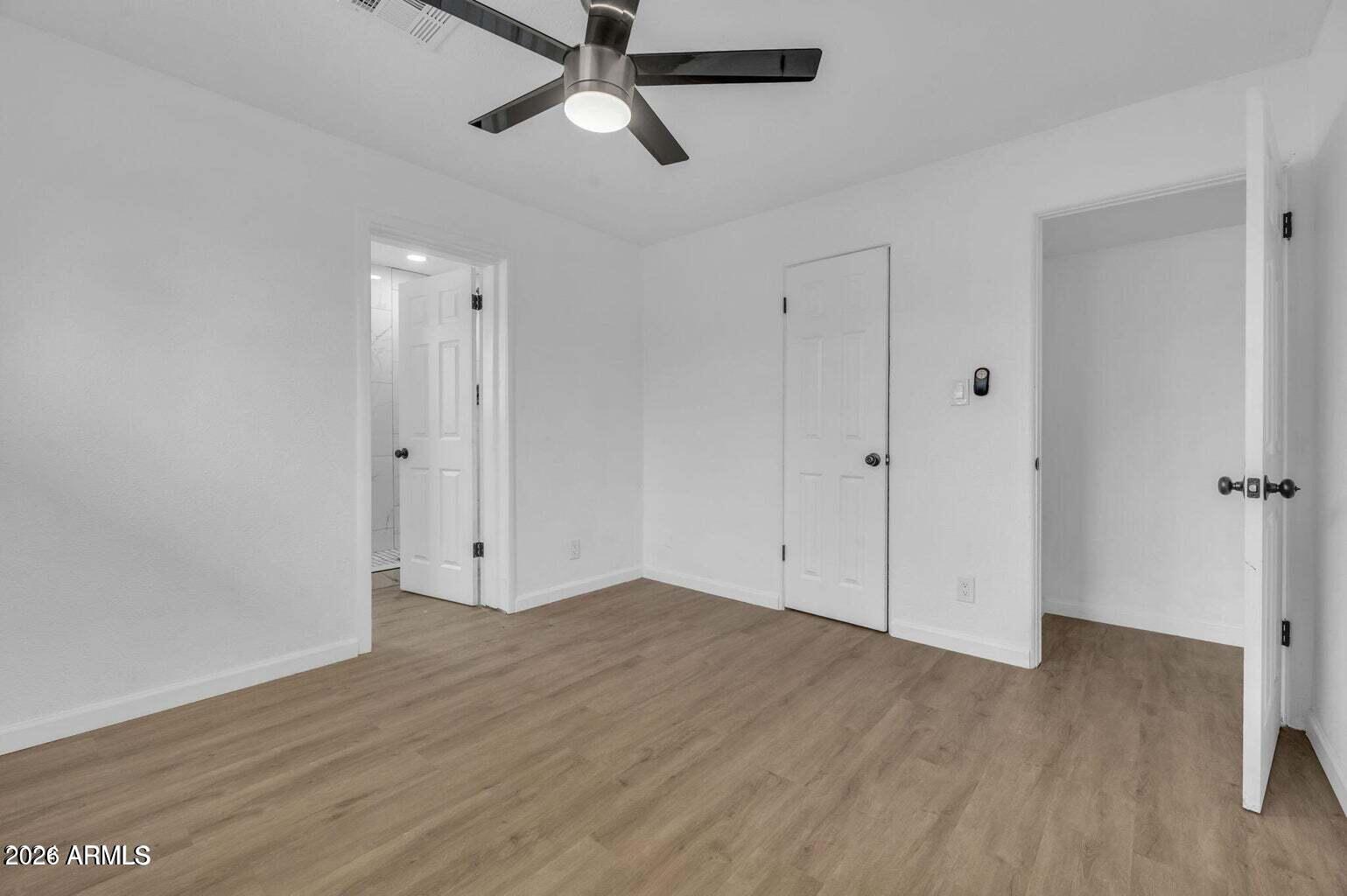 2608 West Pierson Street Phoenix, AZ 85017 - Photo 26 of 32 an empty room with wooden floor closet and windows