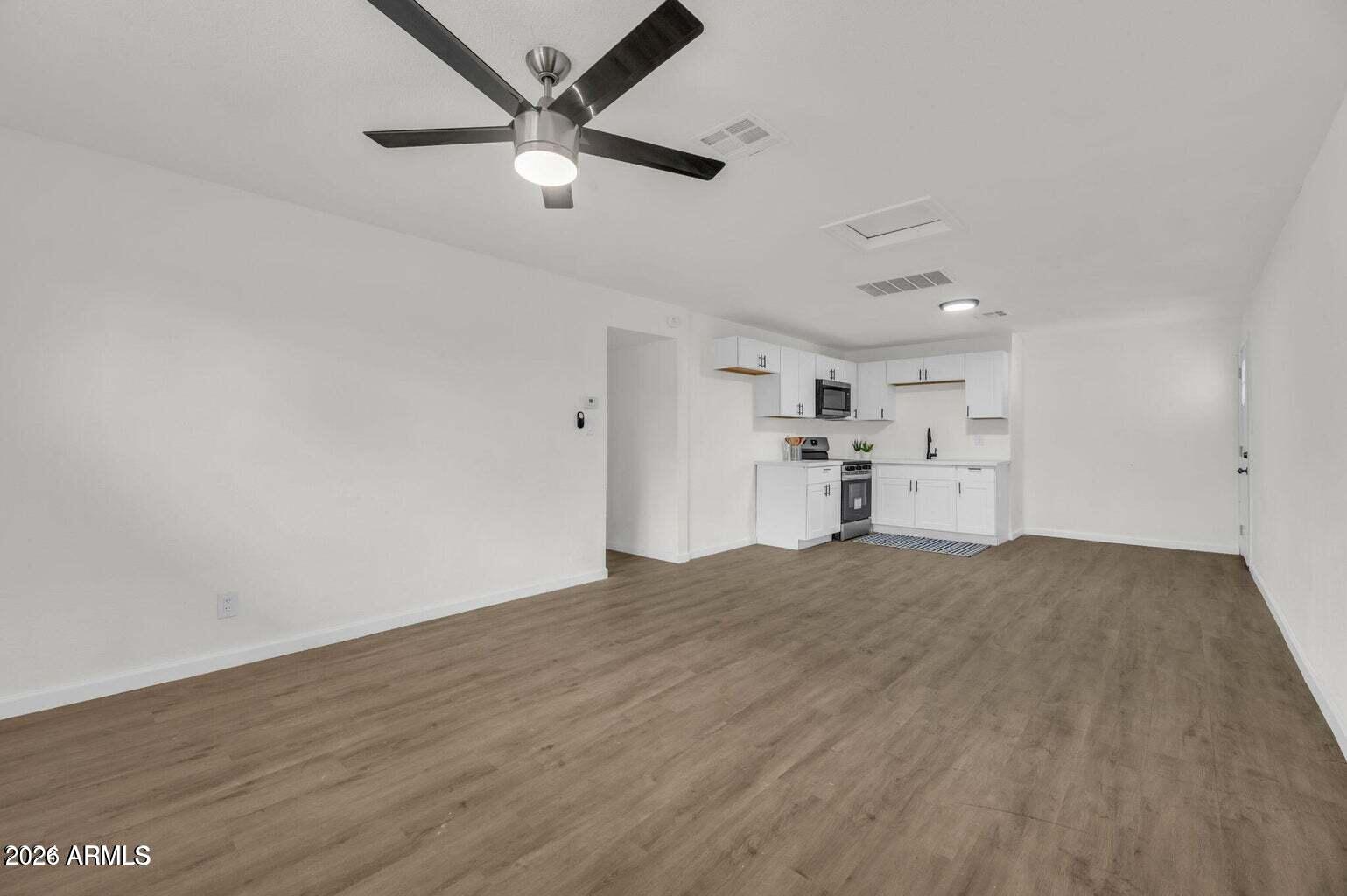 2608 West Pierson Street Phoenix, AZ 85017 - Photo 27 of 32 a view of empty room with wooden floor and windows