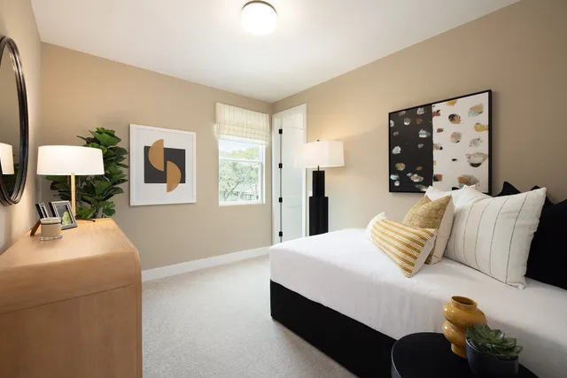 a bedroom with a bed and a table