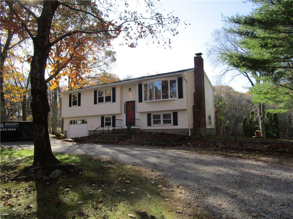 285 Log Bridge Road Coventry, RI 02816 - Photo 1 of 39 Front View of the Home with a stone circular driveway and 1 bay integral garage.