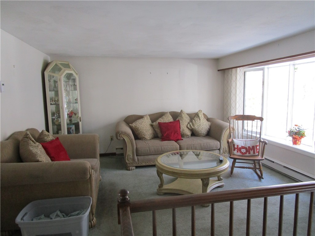 285 Log Bridge Road Coventry, RI 02816 - Photo 14 of 39 Living room finished in wall to wall carpeting and painted walls.