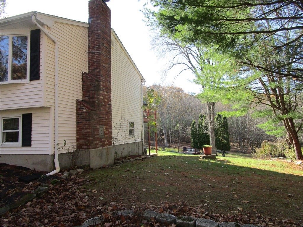285 Log Bridge Road Coventry, RI 02816 - Photo 3 of 39 Right side view of the home look down the depth of the yard.