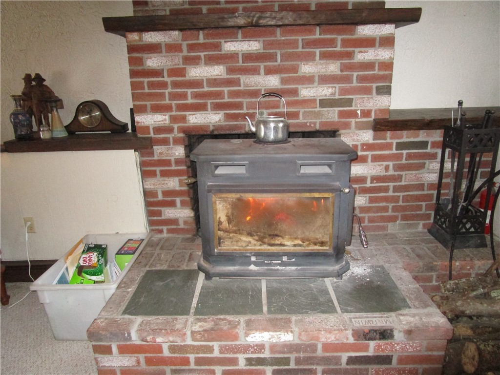 285 Log Bridge Road Coventry, RI 02816 - Photo 32 of 39 Another view of the fireplace/with wood stove. The chimney was cleaned in 2019.