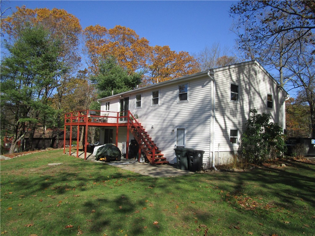 285 Log Bridge Road Coventry, RI 02816 - Photo 4 of 39 Rear view shows the deck and patio area and side of the house.