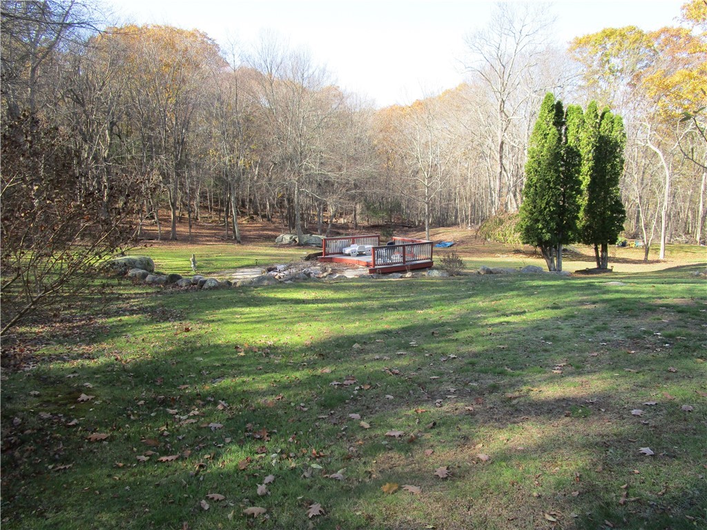 285 Log Bridge Road Coventry, RI 02816 - Photo 9 of 39 View of the back yard looking down to the yard deck and fire pit area.