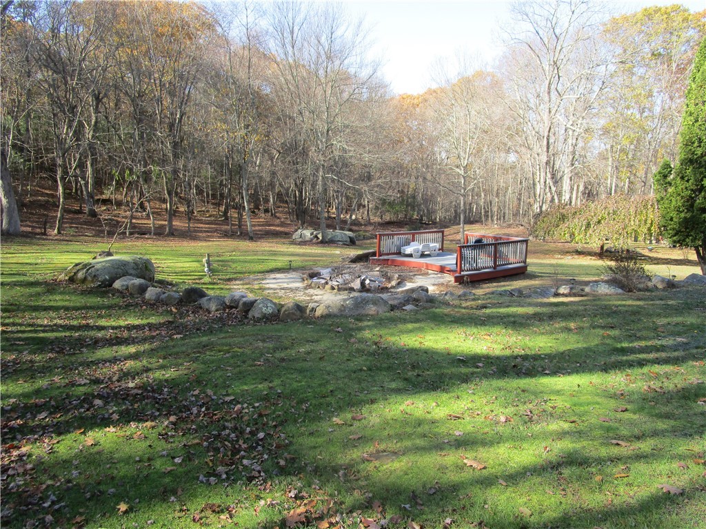 285 Log Bridge Road Coventry, RI 02816 - Photo 10 of 39 Talk about a place to socially distance outside. This yard deck overlooks a gigantic fire pit. Deer and other wild life frequently visit.