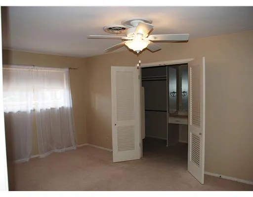 a view of a chandelier fan and livingroom view