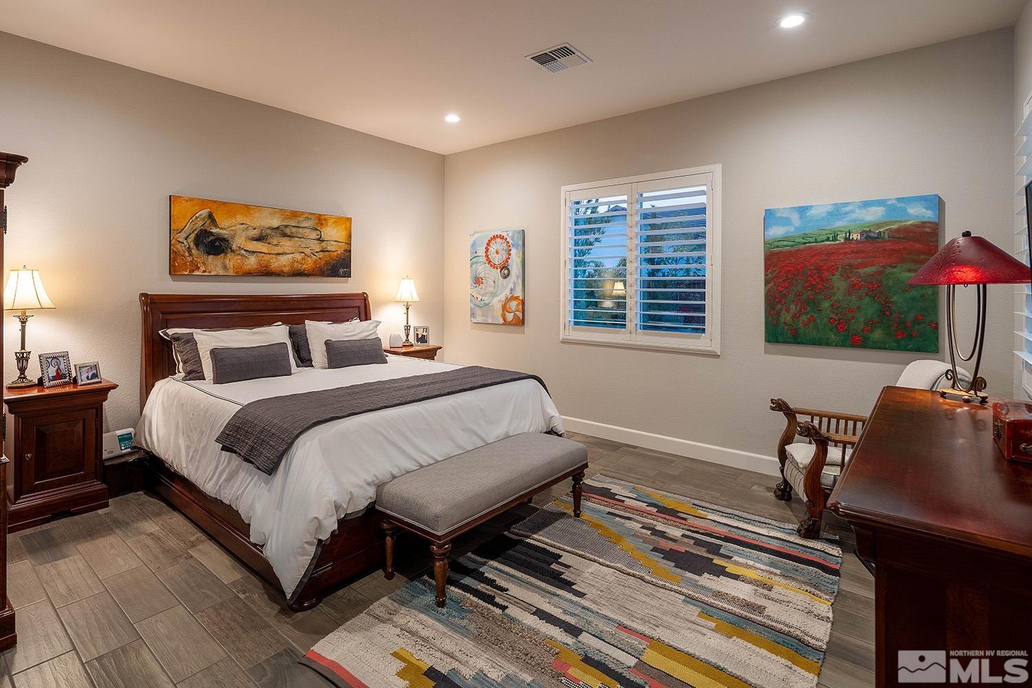 9579 Gazala Lane Reno, NV 89521 - Photo 14 of 40 a bedroom with a bed and a flat screen tv