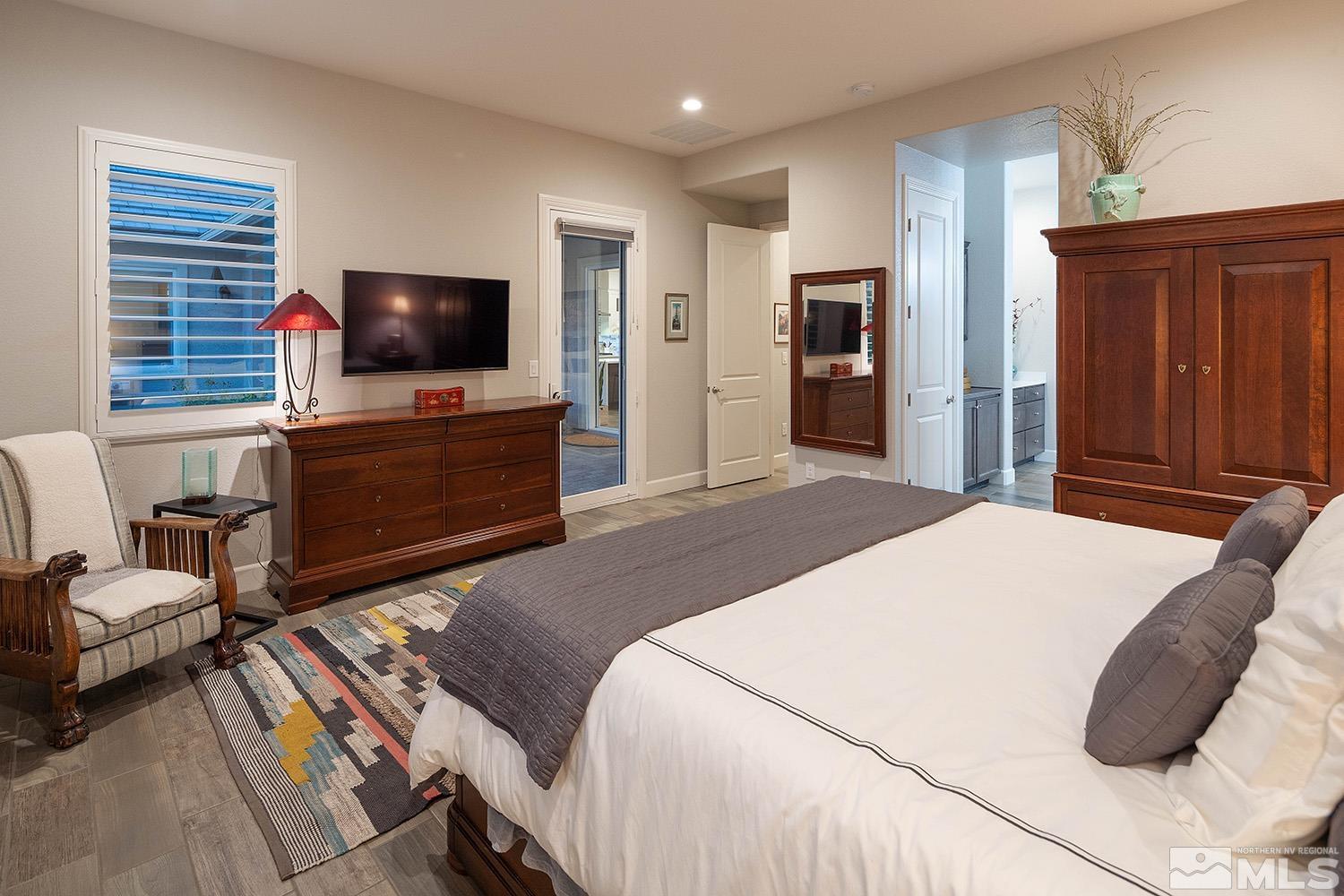 9579 Gazala Lane Reno, NV 89521 - Photo 15 of 40 a bedroom with a bed and a flat screen tv