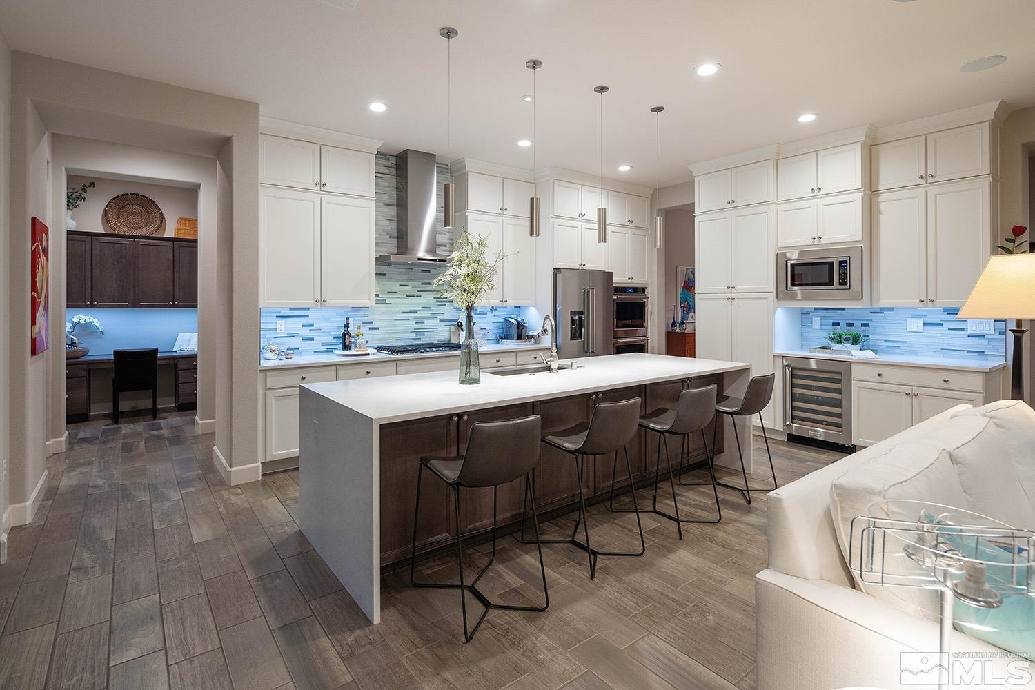 9579 Gazala Lane Reno, NV 89521 - Photo 26 of 40 a kitchen with stainless steel appliances kitchen island granite countertop a sink and a refrigerator