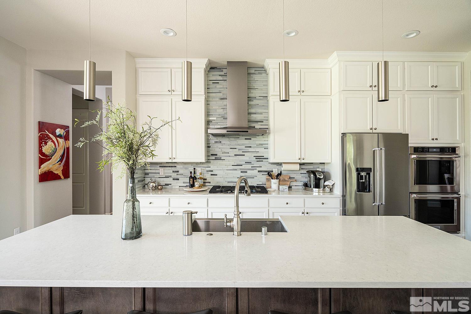9579 Gazala Lane Reno, NV 89521 - Photo 5 of 40 a kitchen with refrigerator and cabinets