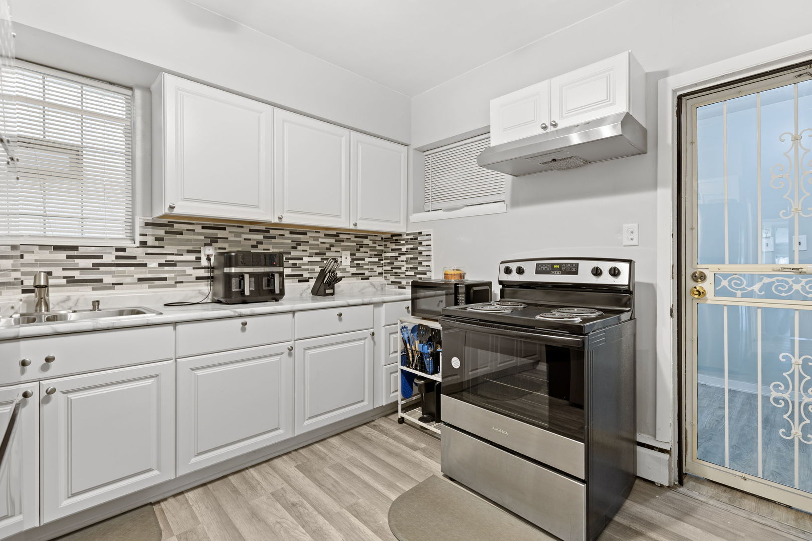 8438 South Morgan Street Chicago, IL 60620 - Photo 6 of 17 a kitchen with cabinets appliances and a sink