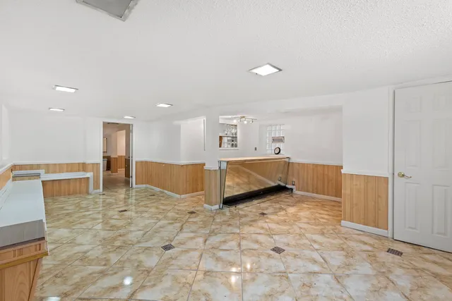 a view of an empty room with kitchen