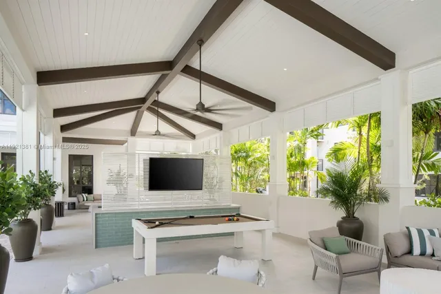 a living room with furniture tv and a large window