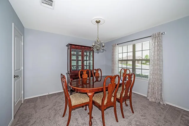 a view of a room with wooden floor and ceiling fan