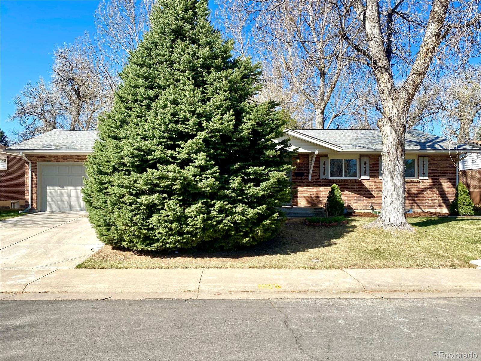 a view of a house with a yard and tree s