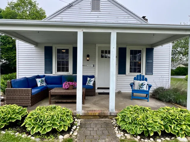a view of a patio with chairs and a flower pot
