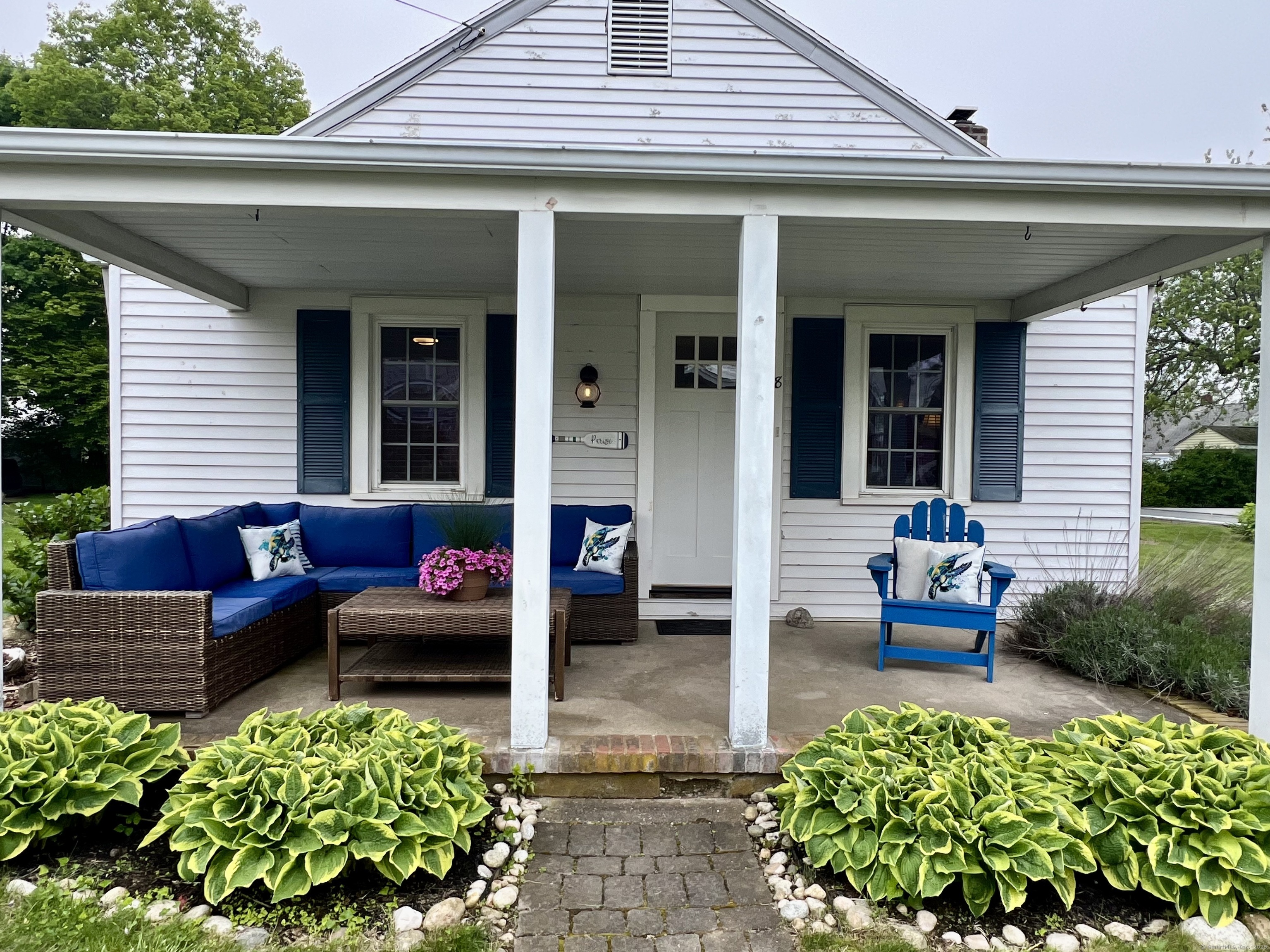 a view of a patio with chairs and a flower pot