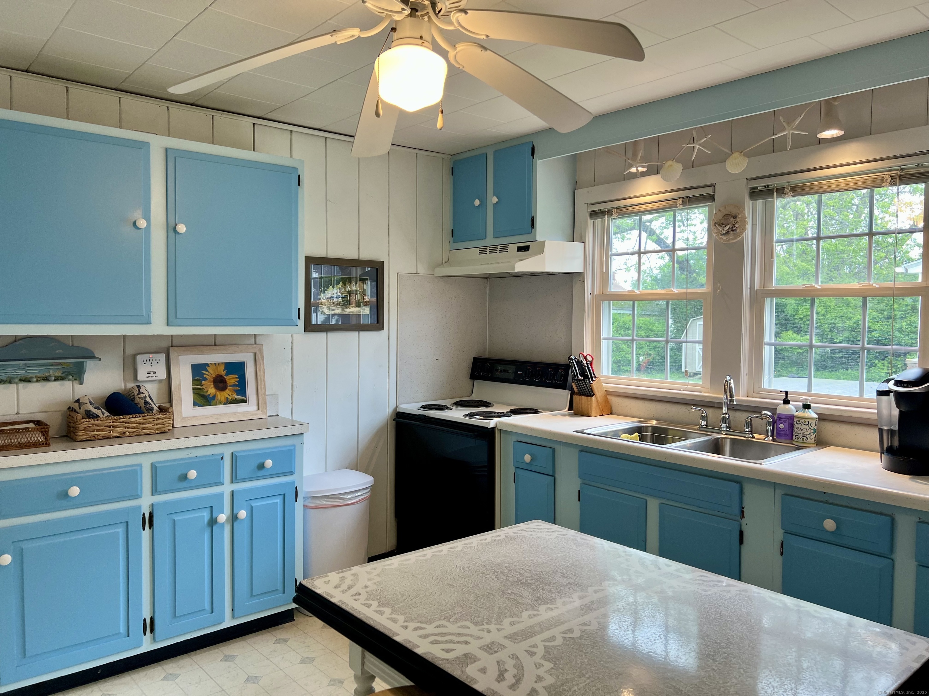 38 Seabreeze Road Old Saybrook, CT 06475 - Photo 11 of 19 a kitchen with a sink stove and cabinets