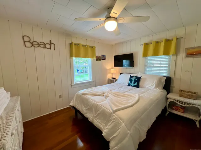 a bedroom with a bed and a tv