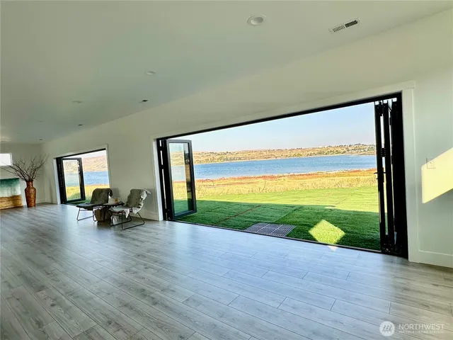 a view of a room with wooden floor and balcony