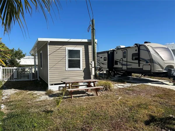 a backyard of a house with barbeque oven