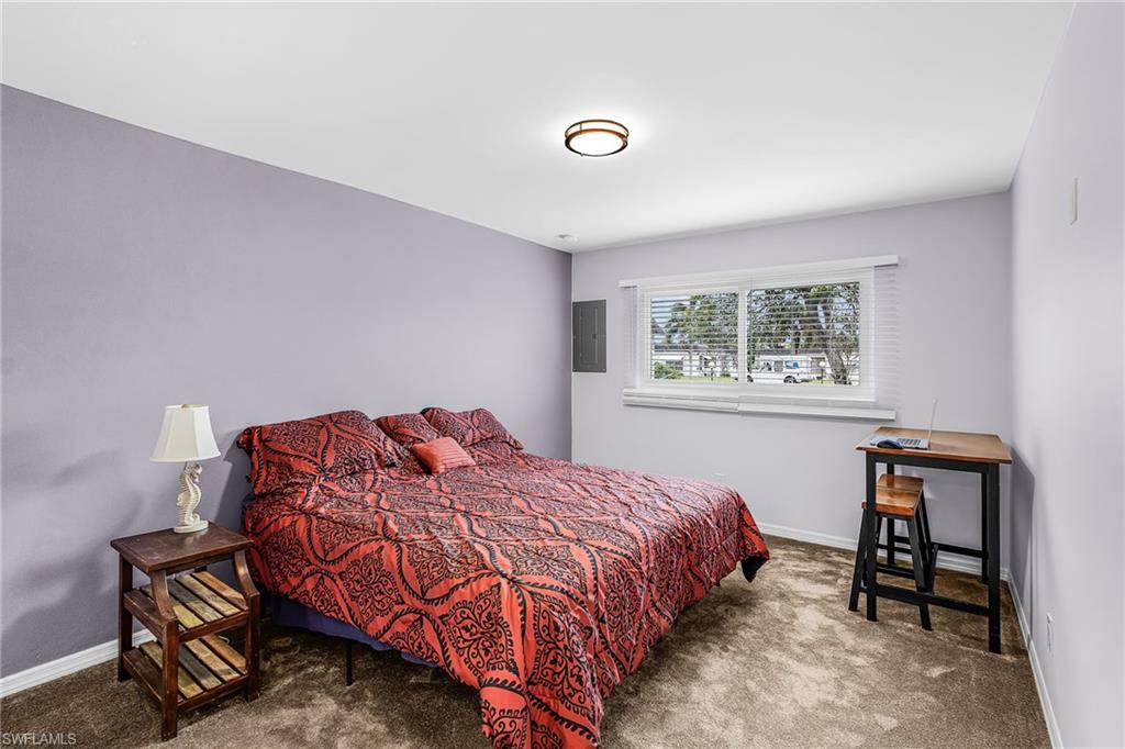 34 Hamlin Court Lehigh Acres, FL 33936 - Photo 14 of 29 a bedroom with a bed and a window