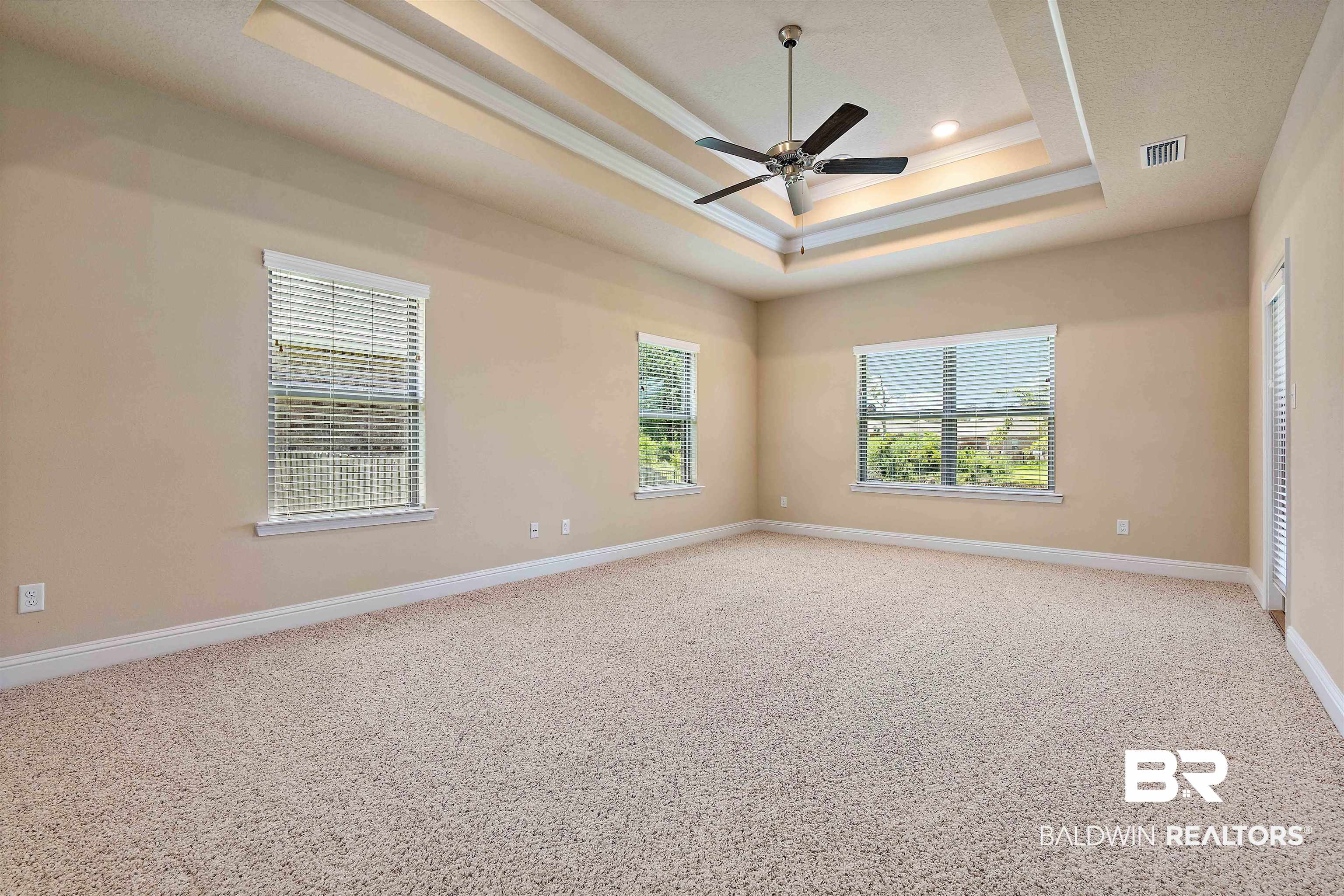 1864 Gwin Court Mobile, AL 36695 - Photo 20 of 37 Spare room with ceiling fan, carpet, and a tray ceiling