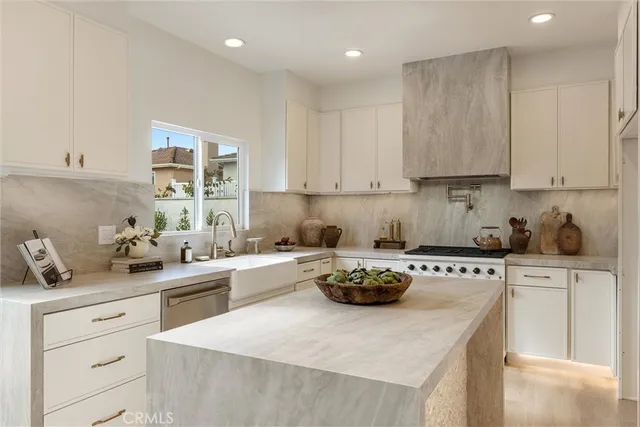 a white stove top oven sitting inside of a kitchen