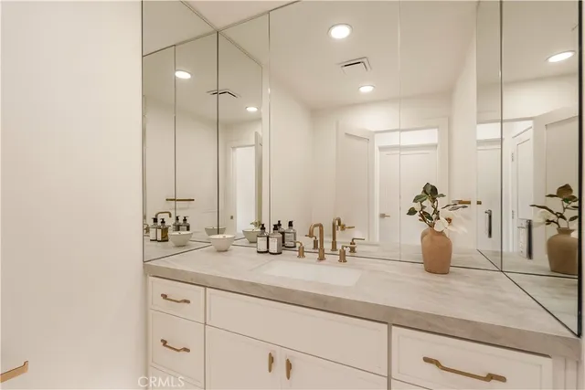 a bathroom with a granite countertop sink a toilet and a mirror