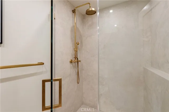 a bathroom with a double vanity sink and mirror with toilet