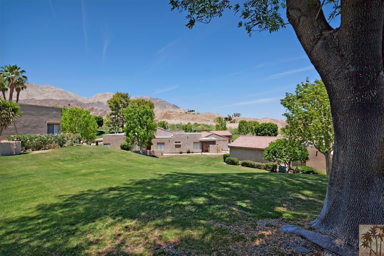 72384 Ridgecrest Lane Palm Desert, CA 92260 - Photo 1 of 23 a backyard of a house with lots of green space