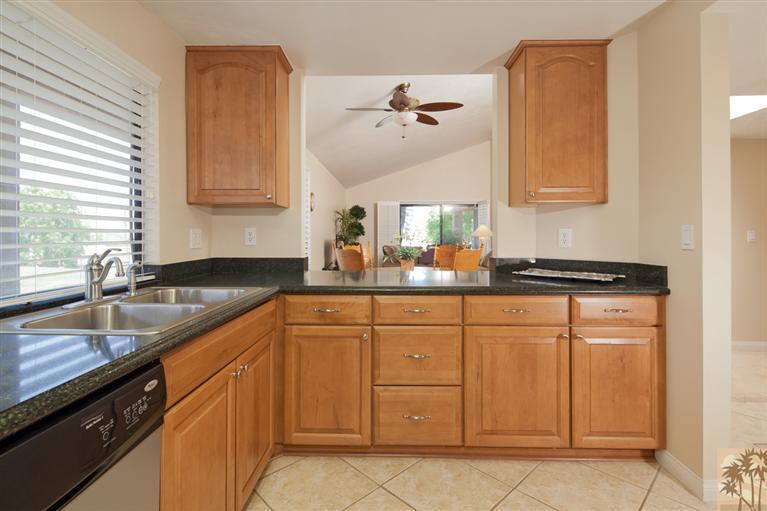 72384 Ridgecrest Lane Palm Desert, CA 92260 - Photo 11 of 23 a kitchen with white cabinets and a sink