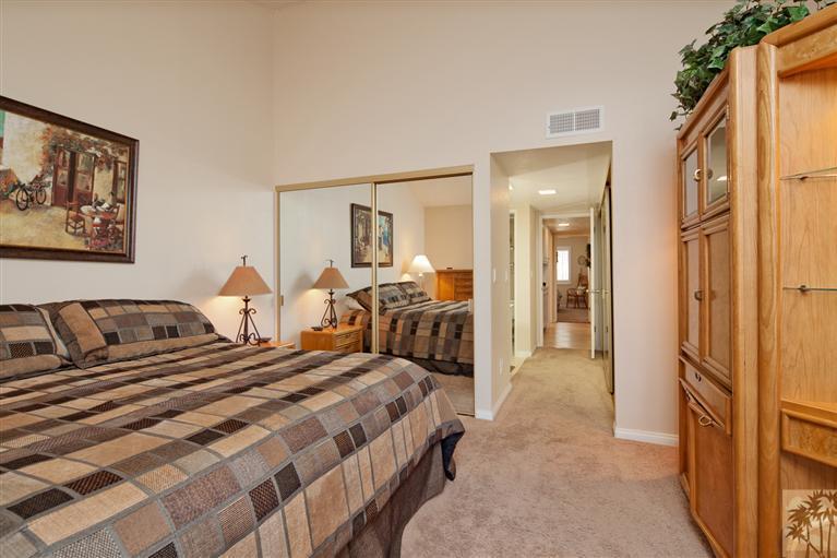 72384 Ridgecrest Lane Palm Desert, CA 92260 - Photo 15 of 23 a bedroom with bed and glass door