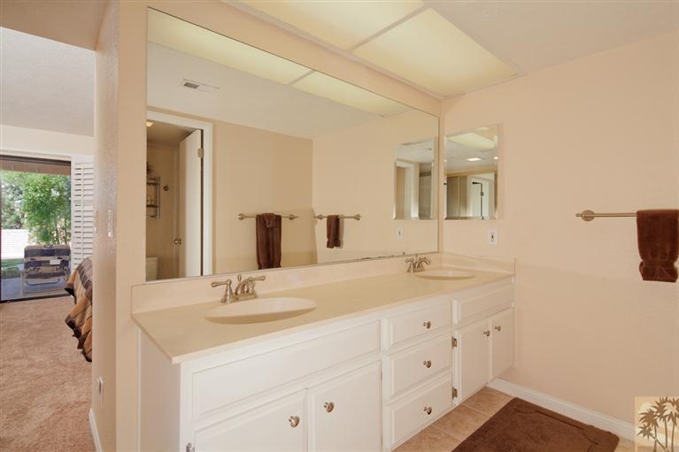 72384 Ridgecrest Lane Palm Desert, CA 92260 - Photo 17 of 23 a bathroom with a double vanity sink and a mirror
