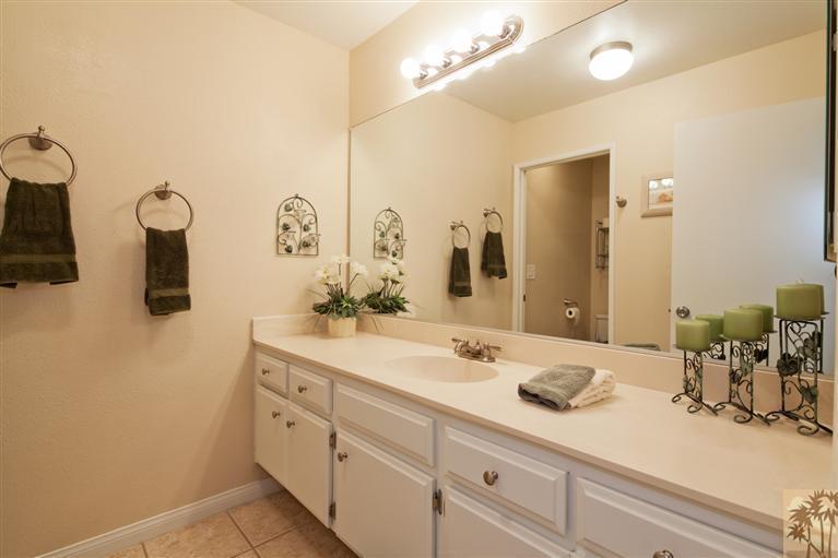 72384 Ridgecrest Lane Palm Desert, CA 92260 - Photo 20 of 23 a bathroom with a double vanity sink mirror and toilet