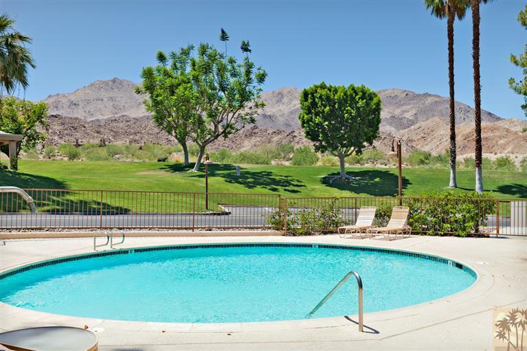 72384 Ridgecrest Lane Palm Desert, CA 92260 - Photo 21 of 23 a view of a swimming pool with a yard
