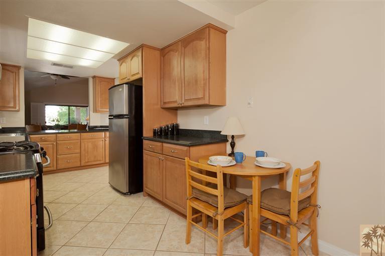 72384 Ridgecrest Lane Palm Desert, CA 92260 - Photo 10 of 23 a kitchen with a sink cabinets and refrigerator